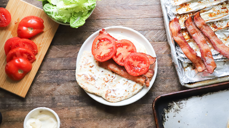 Tomato slices added to sandwich