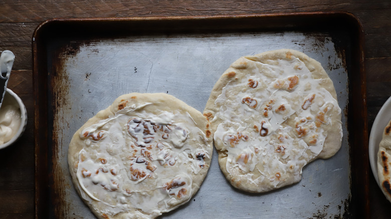 Mayonnaise spread on two flatbreads