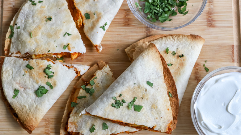 chicken tikka masala quesadillas on a cutting board