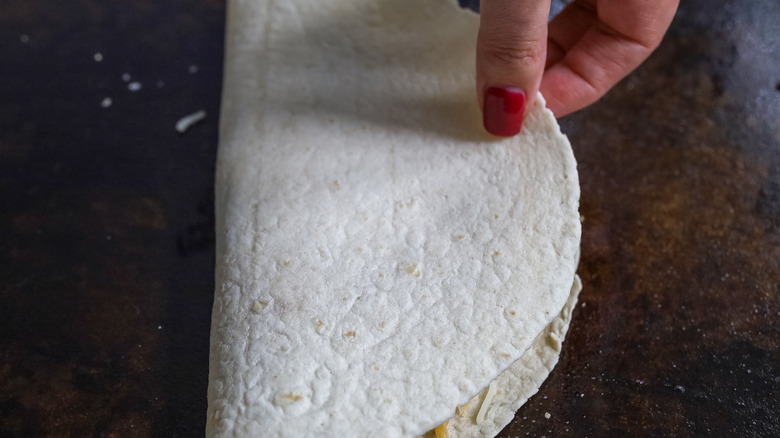 tortilla being folded in half