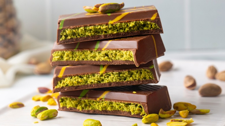 A broken and stacked Dubai chocolate bar with pistachio filling