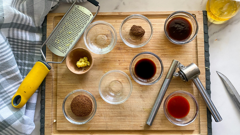 small bowls with sauce ingredients on board