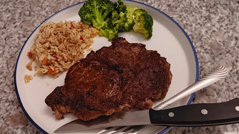 LongHorn Steakhouse ribeye with rice and broccoli on plate