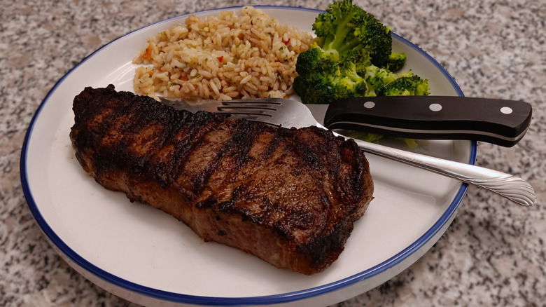 LongHorn Steakhouse New York strip with rice and broccolion plate