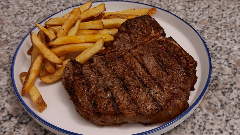 LongHorn Steakhouse T-bone on plate with french fries