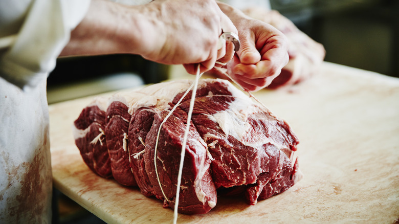 butcher tying beef