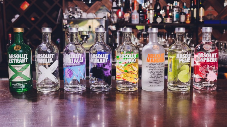 A row of Absolut flavored vodkas on a bartop