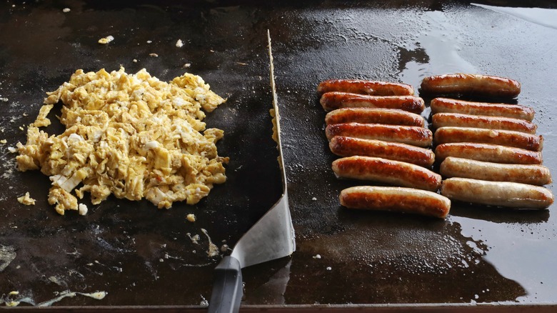 scrambled eggs cooking on a griddle