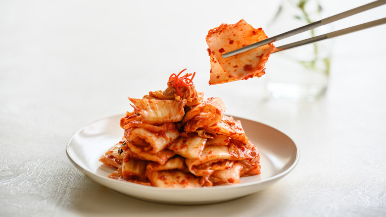 eating from a bowl of kimchi