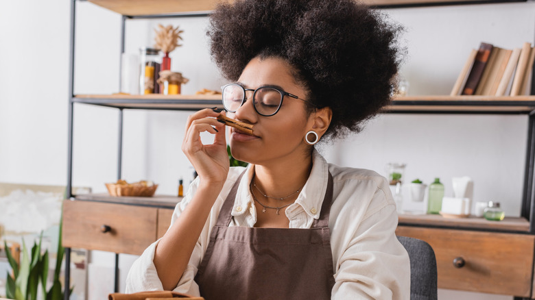 Woman smelling cinnamon stick