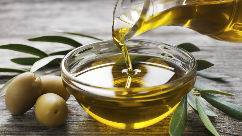 small bowl of olive oil being poured