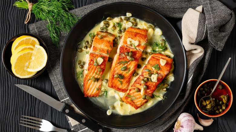 Overview of plated salmon piccata with fresh ingredients