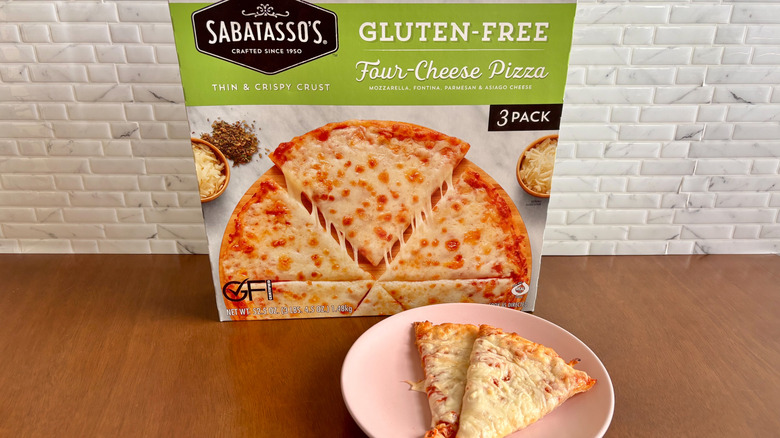 Sabatasso's gluten-free cheese pizza box next to cheese pizza slices on plate