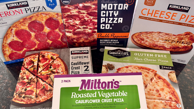 Various Costco pizza boxes on countertop