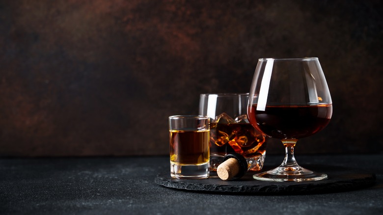 Dark rum in three different sized glasses