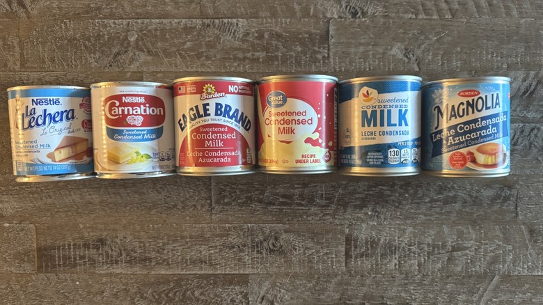 Cans of sweetened condensed milk on wood