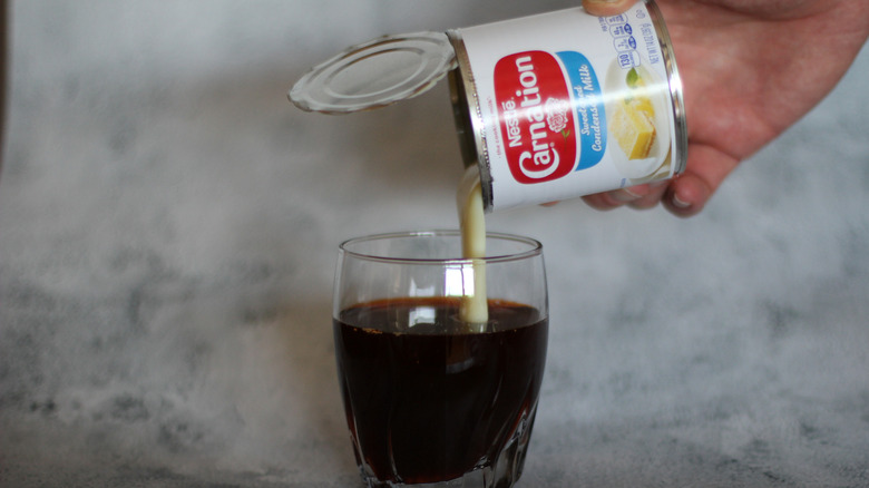 Sweetened condensed milk poured into tea