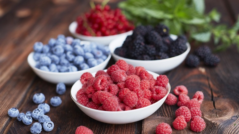 Bowls of raspberries, blackberries, and blueberries