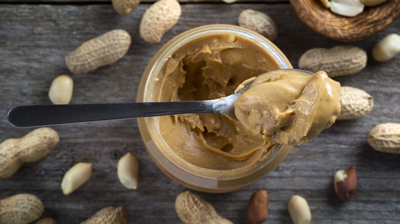 Spoonful of peanut butter with jar