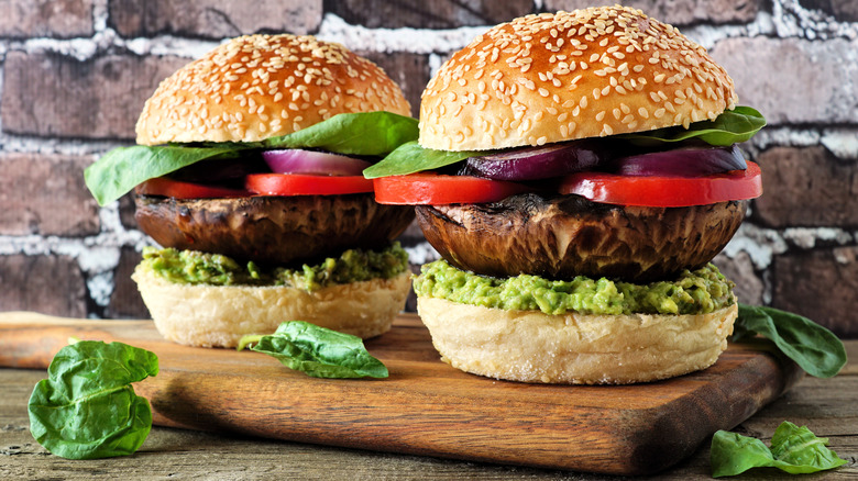 Two portobello mushroom burgers on cutting board