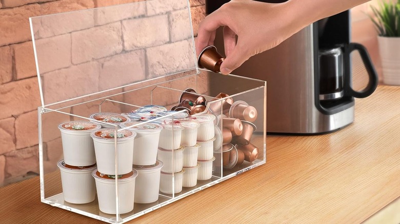 Coffee capsules in acrylic box with three compartments