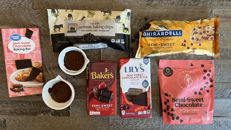 Packaged chocolates are arranged on a table with cups.