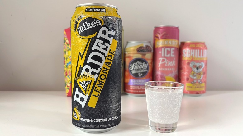 Mike's Harder Lemonade next to shot glass of lemonade on white table