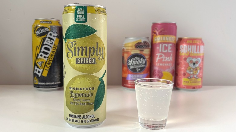 Simply Spiked Signature Lemonade next to shot glass of lemonade on white table