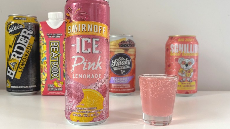 Smirnoff Ice Pink Lemonade next to shot glass of lemonade on white table
