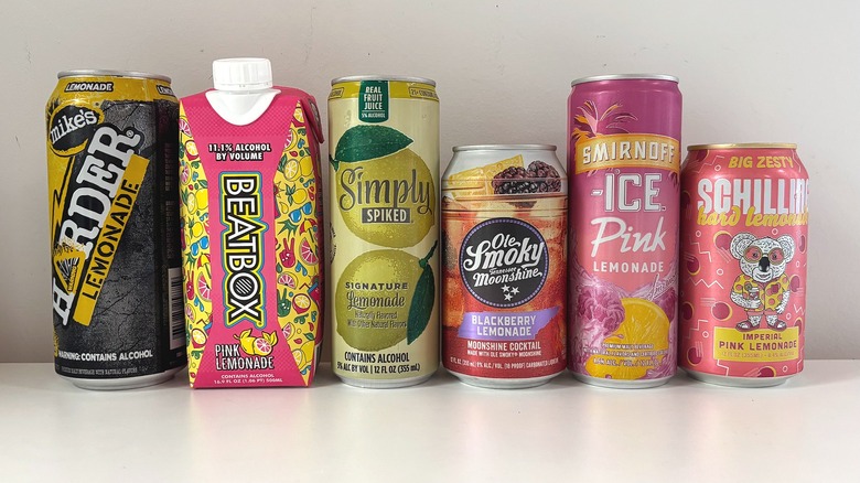 Six hard lemonade containers lined up on white table