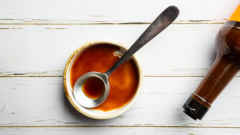 small bowl of Worcestershire sauce with bottle