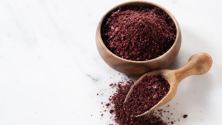 Wooden bowl and spoon filled sumac