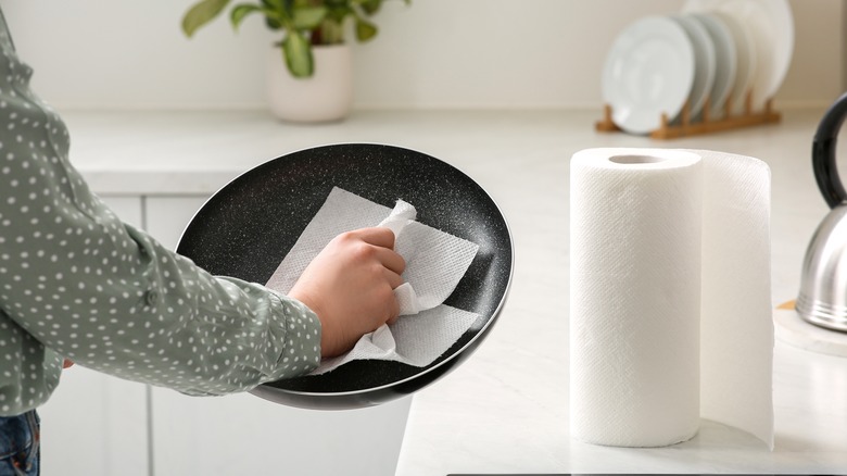 wiping pan with paper towel