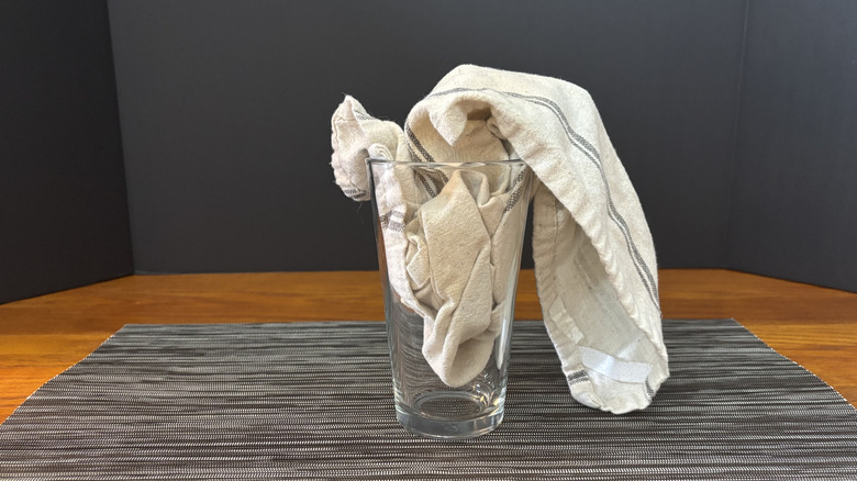 Pint glass with bar towel on bar mat