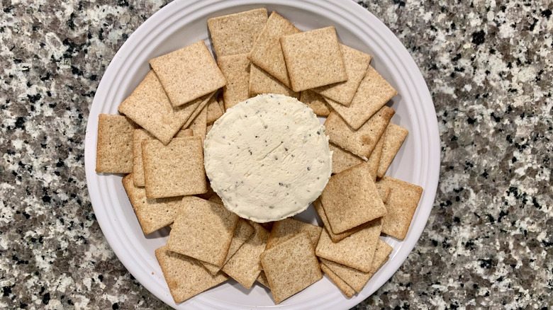 boursin cheese and crackers on table