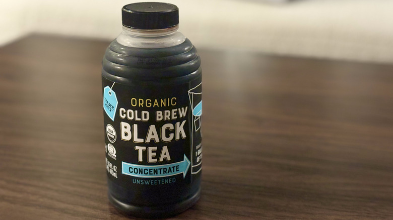 Bottle reading "Organic Cold Brew Black Tea Concentrate" on table