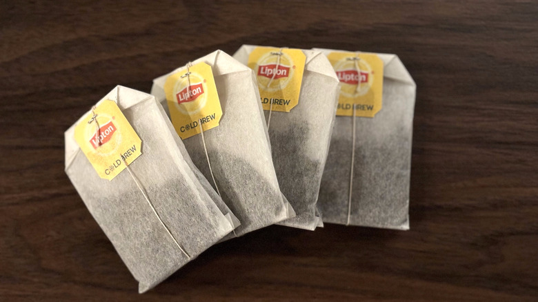 Close-up of four bags of Lipton Cold Brew tea on table