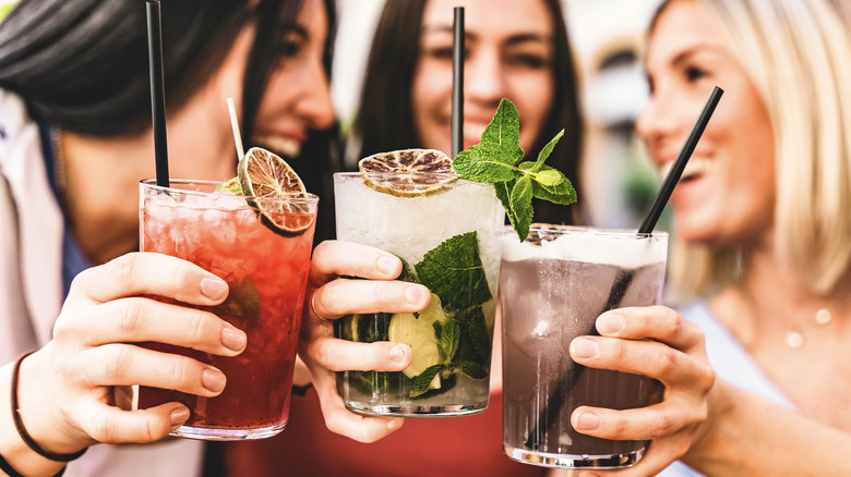 three women drinking cocktails