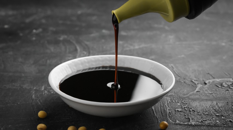 Soy sauce pouring into bowl
