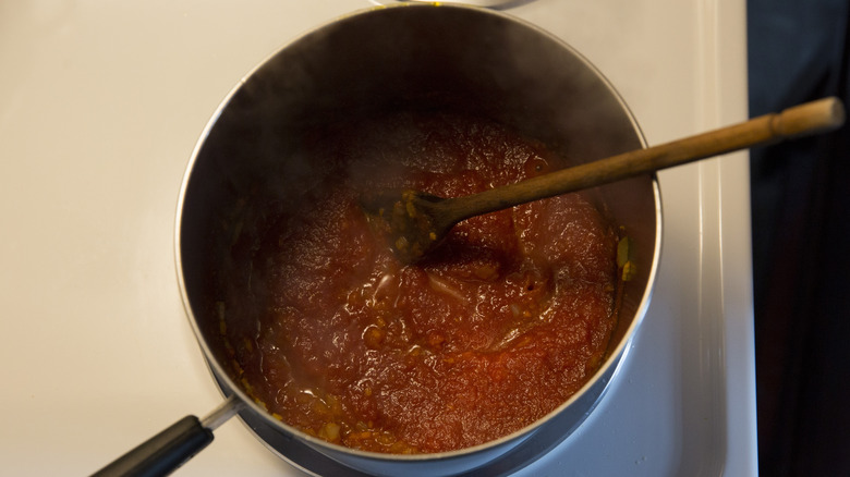 canned tomatoes boiling in pan 
