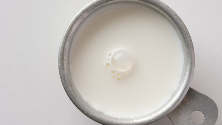Heavy cream in a measuring cup