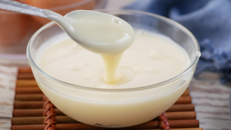 Condensed milk in a bowl with spoon