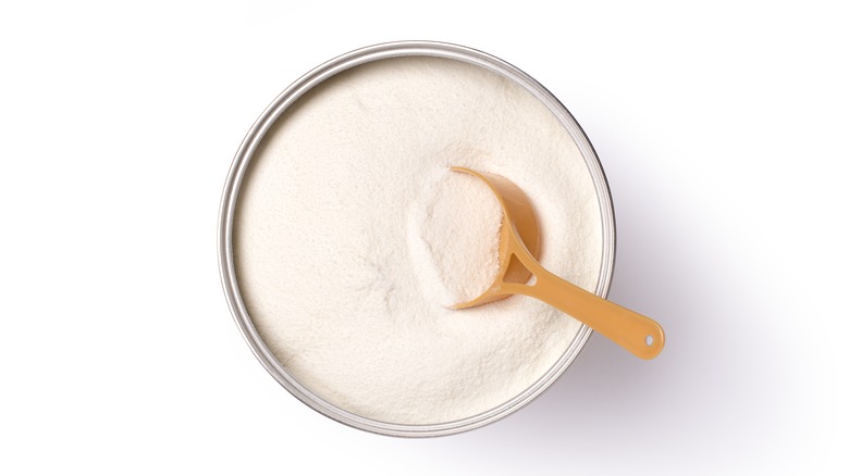 Milk powder in can with scoop