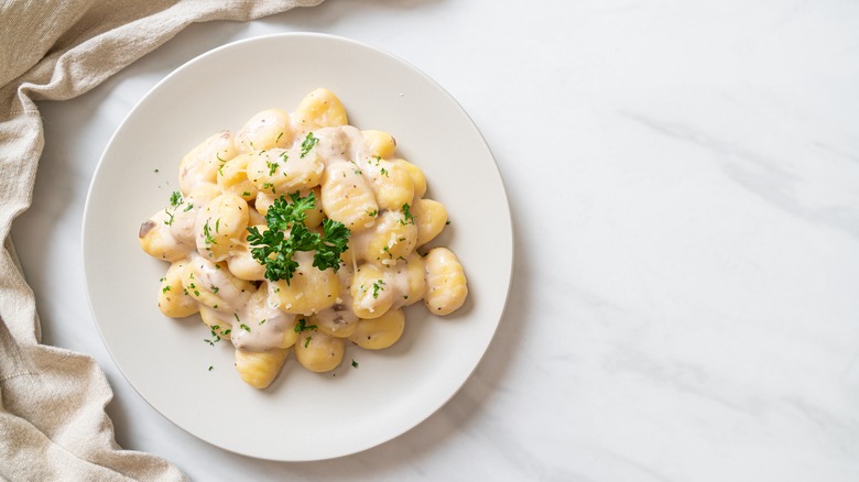 cream sauce gnocchi with parsley