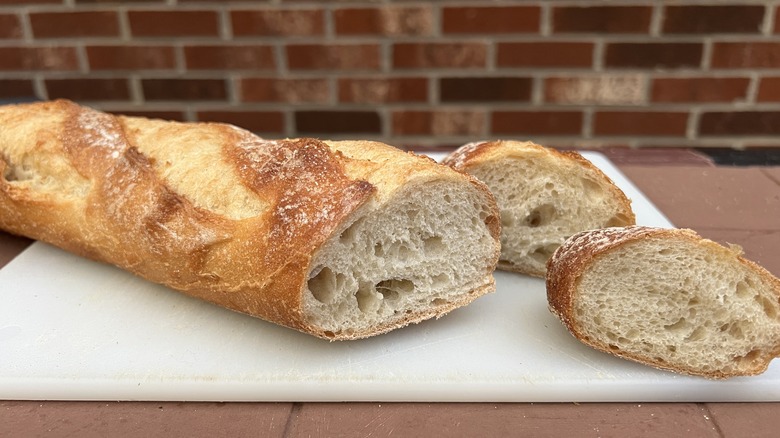 Sliced baguette on cutting board