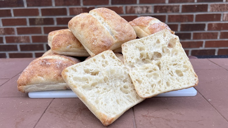 Sliced artisan roll with more in background