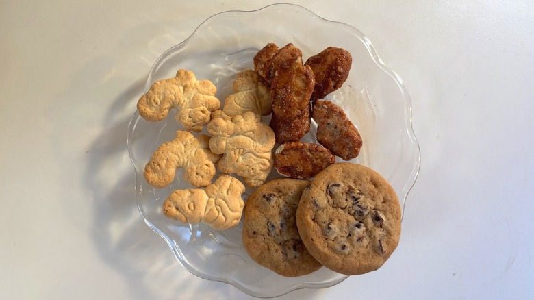 Glass plate with sweet Kirkland snacks on white table