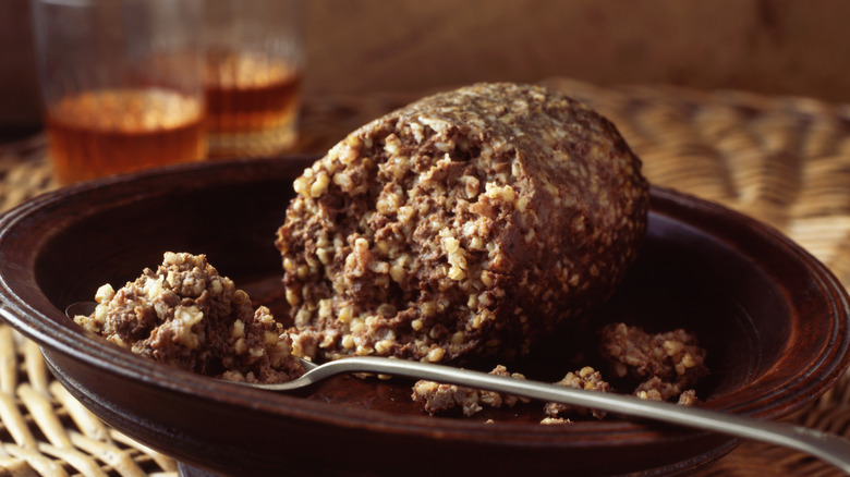 Haggis loaf on plate with spoonful of meat