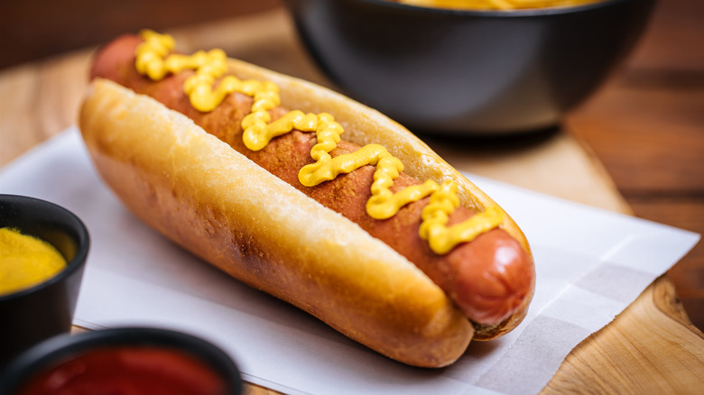 hot dog topped with mustard