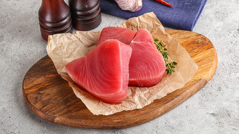 raw tuna steaks on cutting board